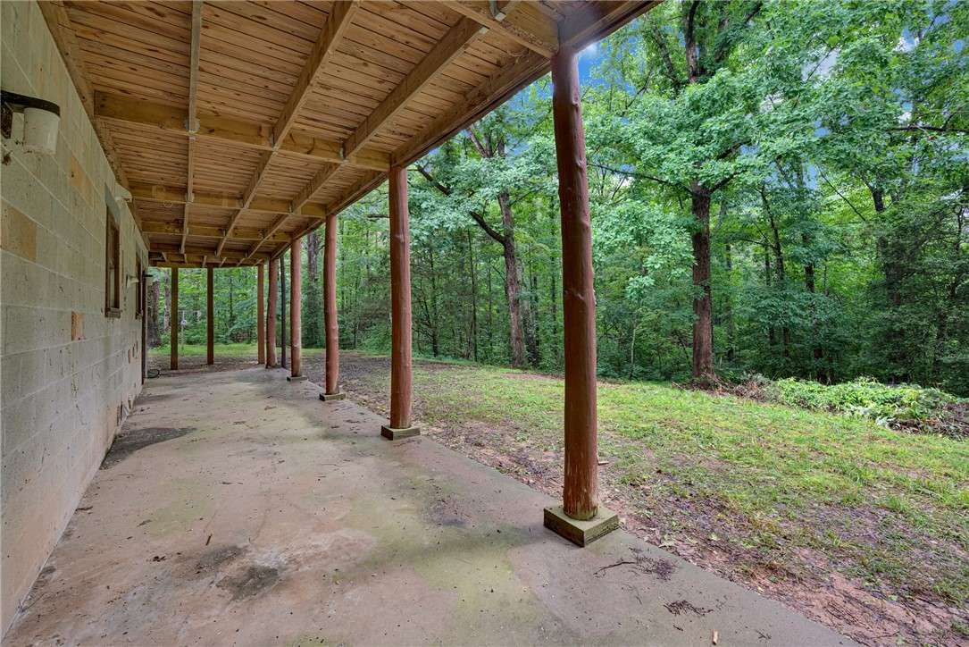 237 Spring Valley Road Liberty, SC 29657 - Photo 25 of 50 Discover a tranquil, wood-lined covered patio perfect for outdoor relaxation.