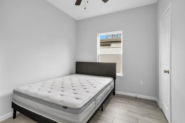 a bedroom with a bed and a window