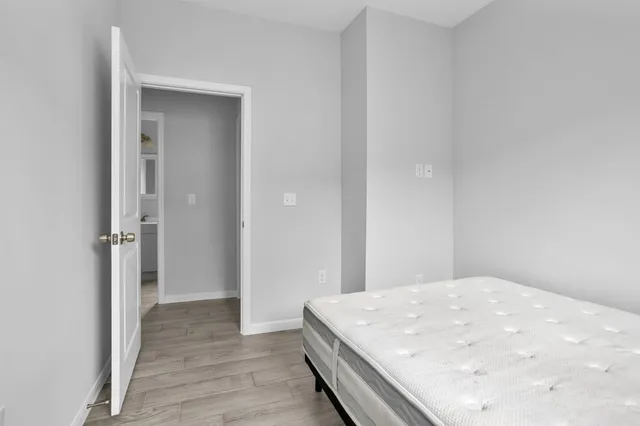 a large white bed in a white room