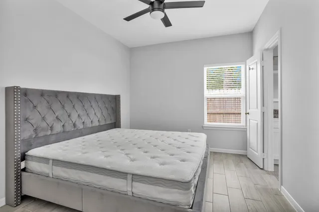 a bedroom with a bed and a window