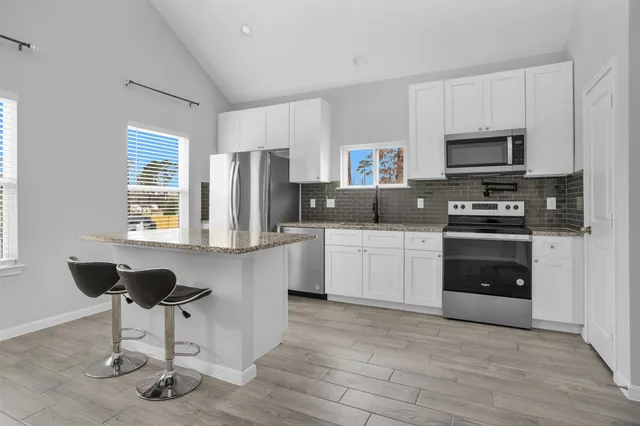 a kitchen with a sink cabinets and stainless steel appliances