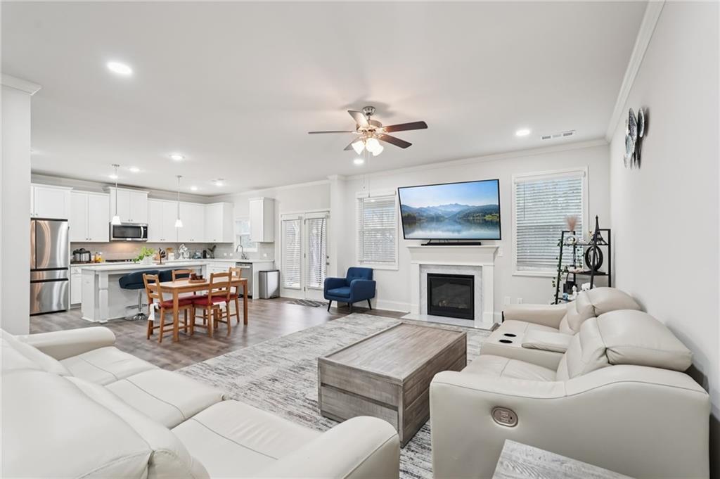 177 Treeline Trail Canton, GA 30115 - Photo 13 of 66 a living room with furniture a fireplace and a chandelier
