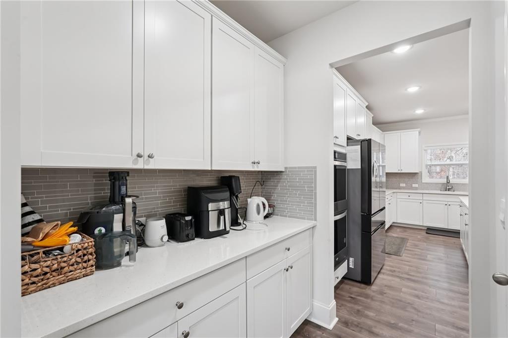 177 Treeline Trail Canton, GA 30115 - Photo 17 of 66 a kitchen with stainless steel appliances a refrigerator a sink and white cabinets
