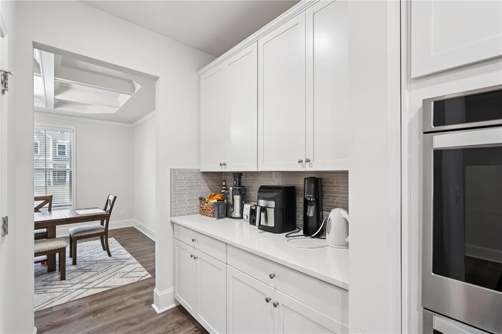 177 Treeline Trail Canton, GA 30115 - Photo 19 of 66 a kitchen with stainless steel appliances white cabinets and wooden floor
