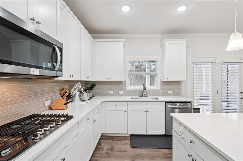 177 Treeline Trail Canton, GA 30115 - Photo 26 of 66 a kitchen with stainless steel appliances a sink dishwasher stove and white cabinets