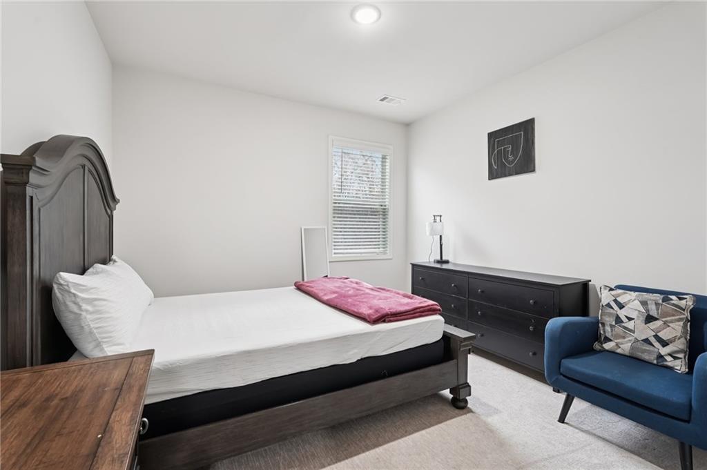 177 Treeline Trail Canton, GA 30115 - Photo 29 of 66 a bedroom with a bed and couch