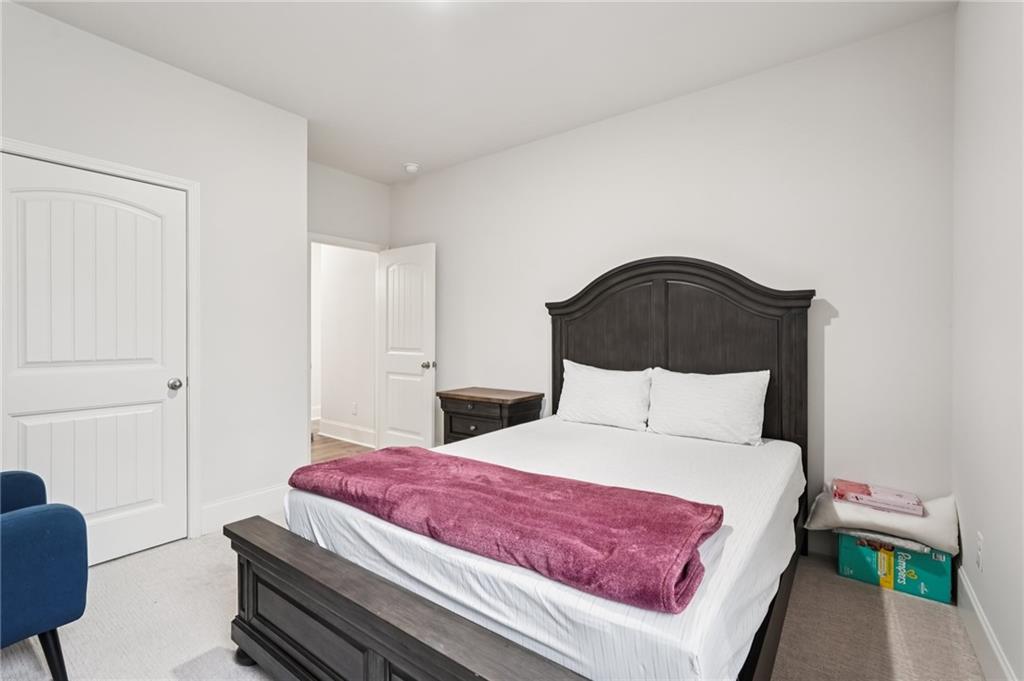 177 Treeline Trail Canton, GA 30115 - Photo 30 of 66 a bedroom with a bed and a couch