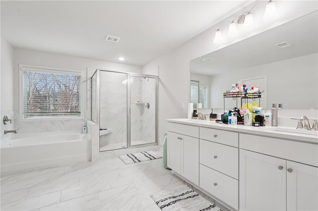 177 Treeline Trail Canton, GA 30115 - Photo 33 of 66 a spacious bathroom with a tub sink and mirror
