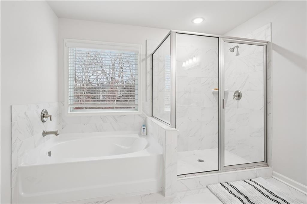 177 Treeline Trail Canton, GA 30115 - Photo 36 of 66 a bathroom with a bathtub and a shower