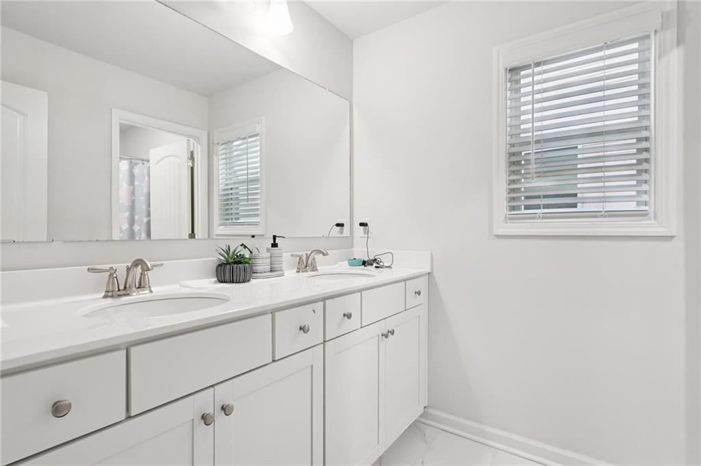 177 Treeline Trail Canton, GA 30115 - Photo 43 of 66 a bathroom with double sink and a mirror