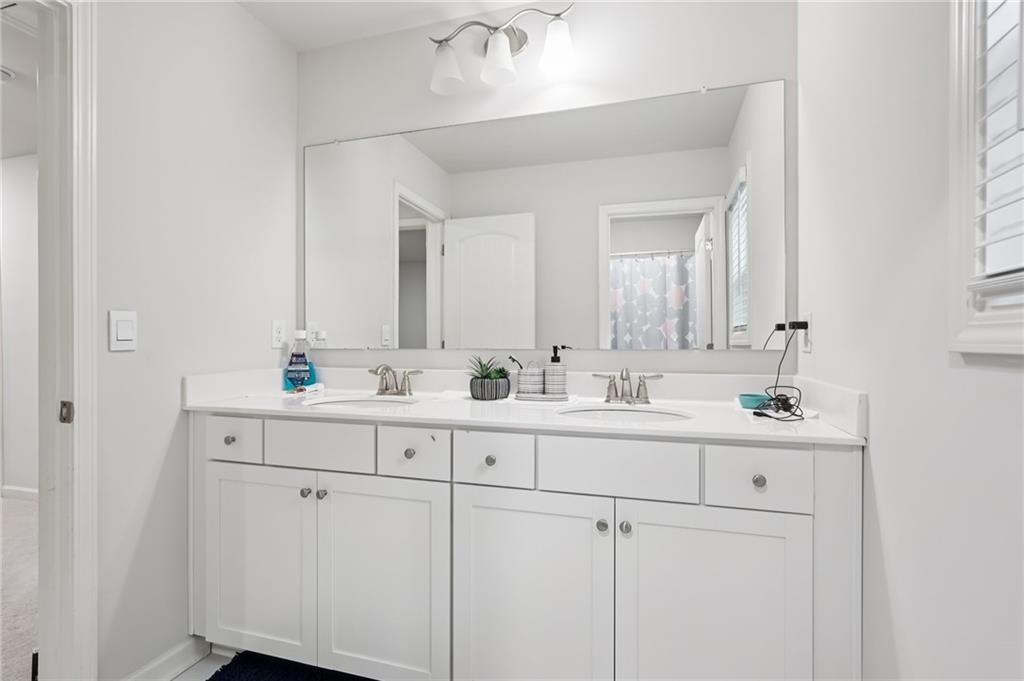 177 Treeline Trail Canton, GA 30115 - Photo 44 of 66 a bathroom with double sink and a mirror