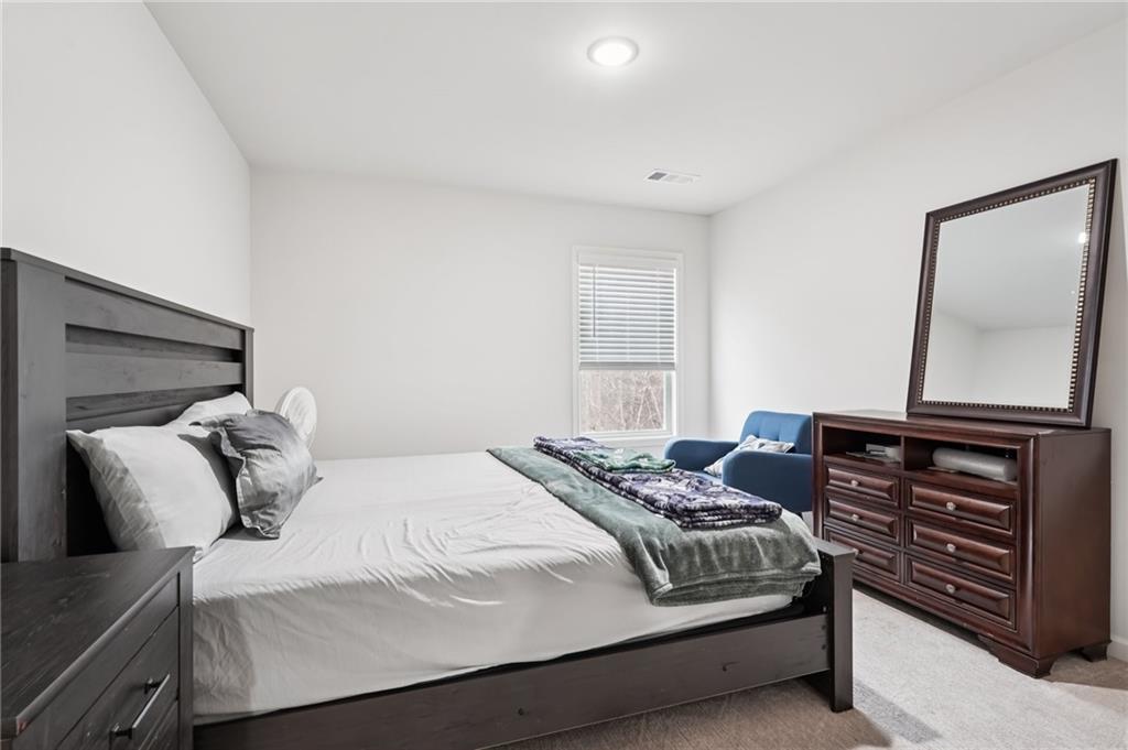 177 Treeline Trail Canton, GA 30115 - Photo 49 of 66 a bedroom with a bed and a dresser