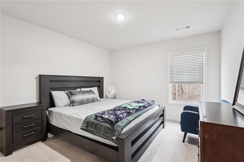 177 Treeline Trail Canton, GA 30115 - Photo 50 of 66 a bedroom with a bed and a desk in it