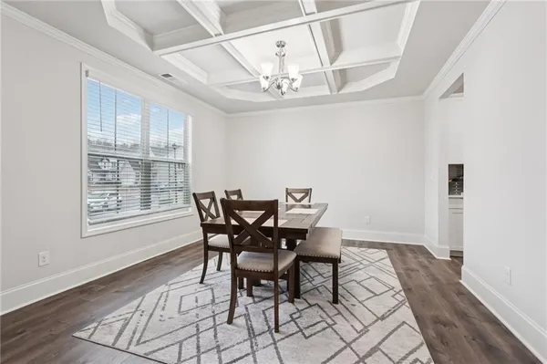 a view of a dining room with furniture and a chandelier
