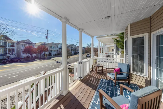 a living room with furniture fireplace and a large window