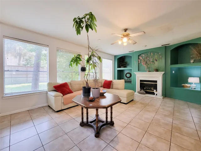 a living room with furniture and a fireplace