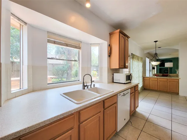 a kitchen with a sink and large cabinets