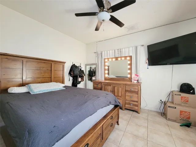 a bedroom with a bed and flat screen tv
