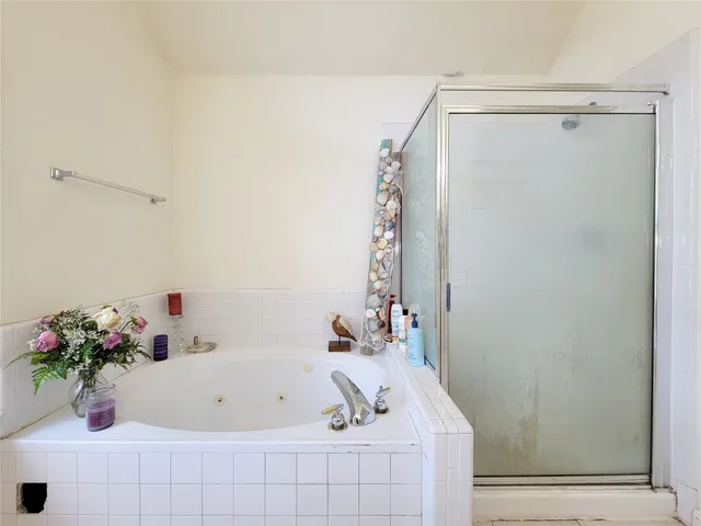 a bathroom with a tub and shower