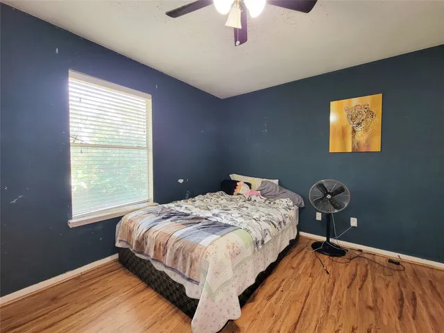 a bedroom with bed and a window