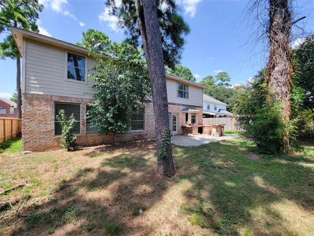 a house that has a tree in front of it