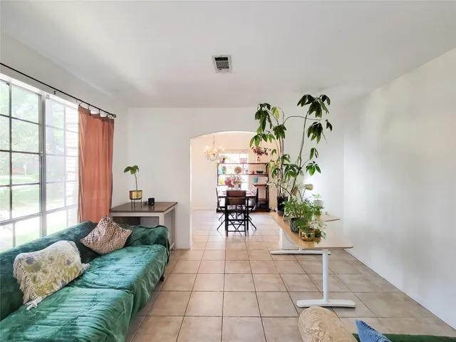 a living room with furniture and a potted plant