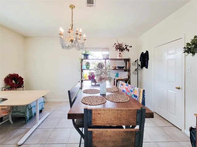 a view of a dining room with furniture and chandelier