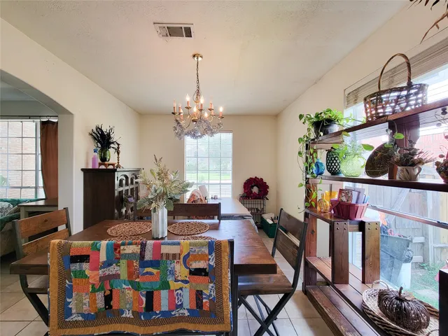 a bedroom with furniture and a chandelier