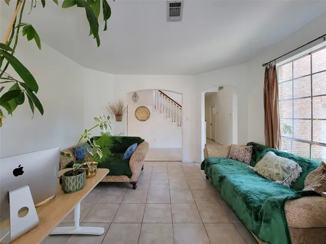 a living room with furniture and a potted plant