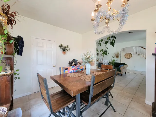 a view of a dining room with furniture and chandelier