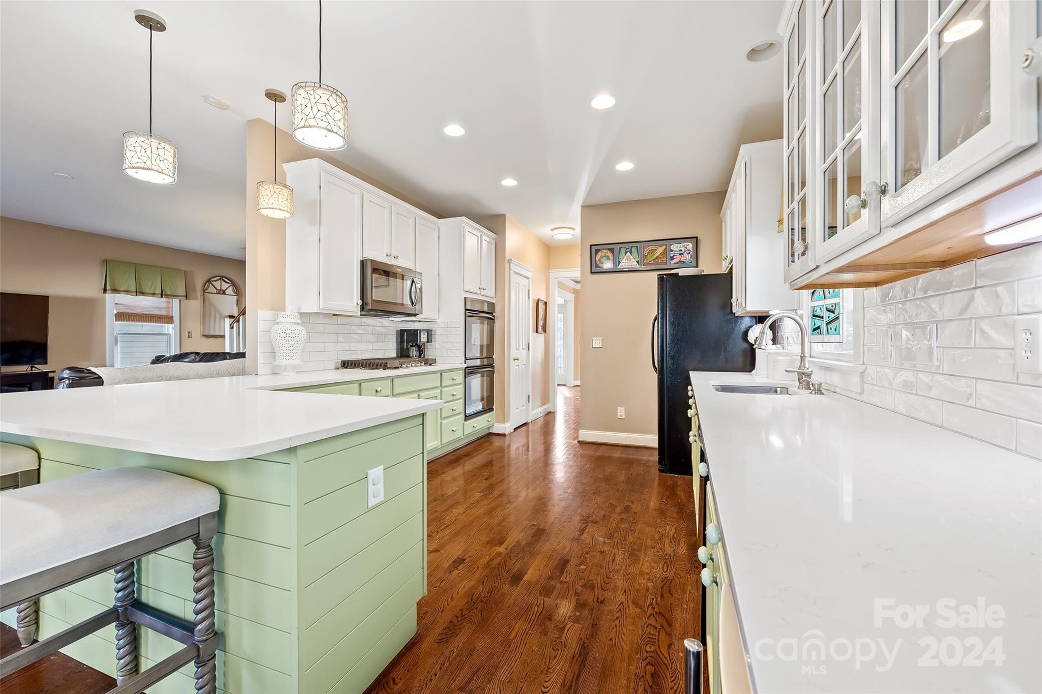 422 Bull Finch Bend Fort Mill, SC 29708 - Photo 13 of 48 a kitchen with stainless steel appliances granite countertop a refrigerator a sink dishwasher a stove and white cabinets with wooden floor