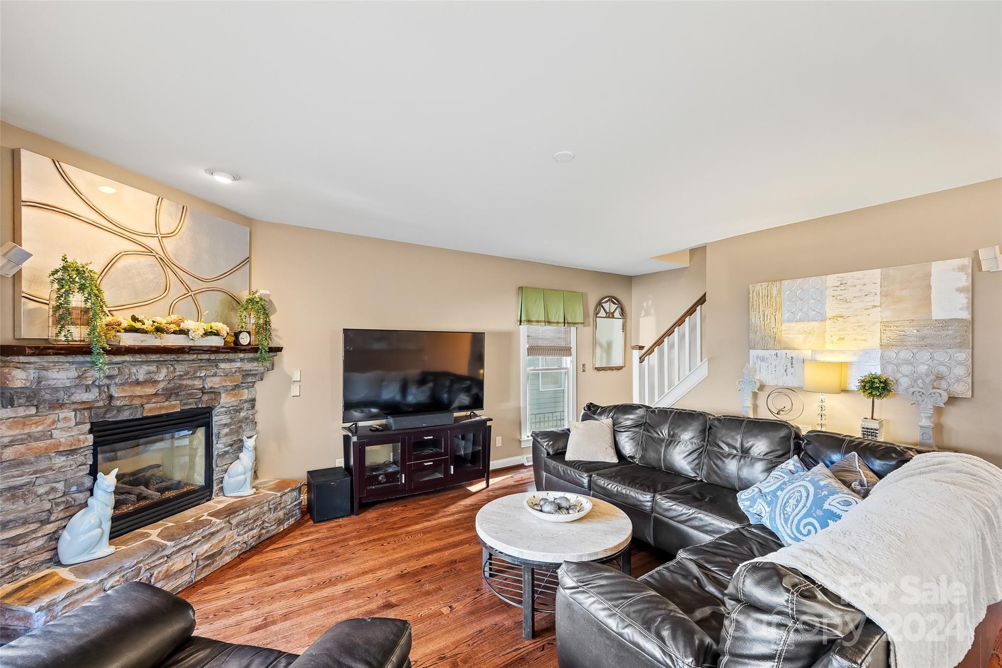 422 Bull Finch Bend Fort Mill, SC 29708 - Photo 10 of 48 a living room with furniture a fireplace and a flat screen tv