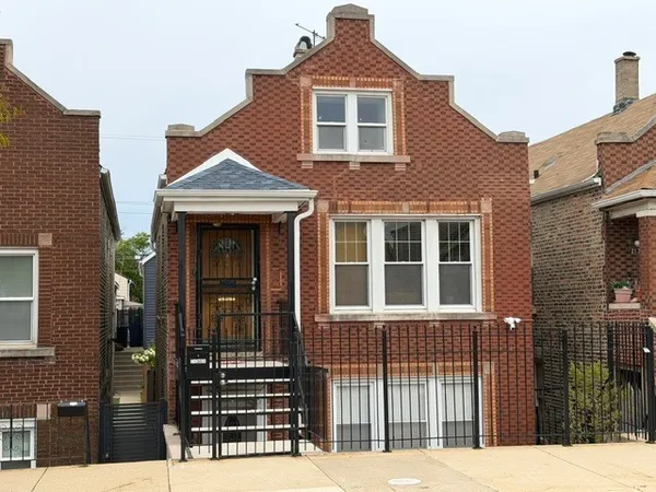 a front view of a house with a fence