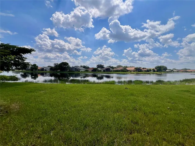 a view of a lake with houses in the background