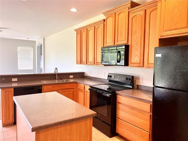 a kitchen with a sink a stove and a refrigerator