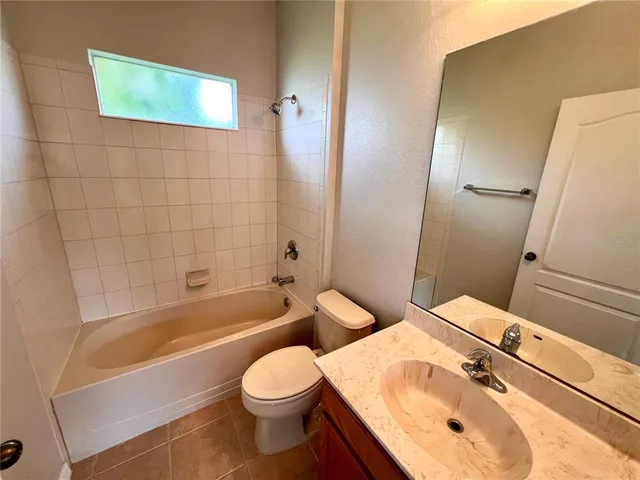 a bathroom with a sink a toilet and bathtub