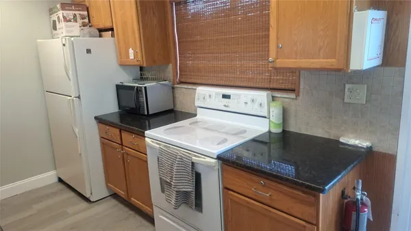 a kitchen with a sink a refrigerator and cabinets