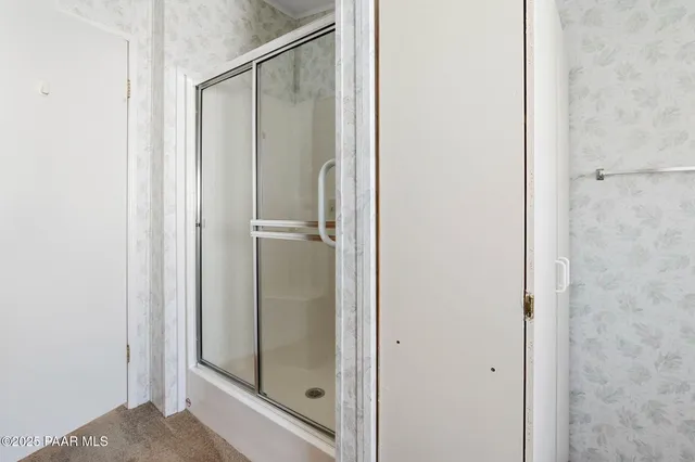 a bathroom with a glass shower door