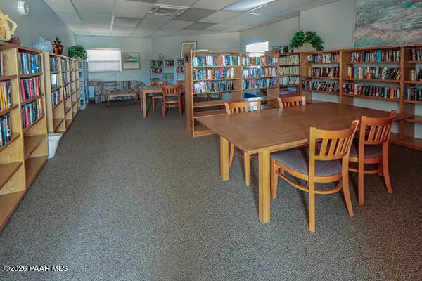 a dining room with furniture and a book shelf