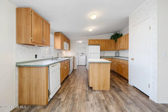 a kitchen with stainless steel appliances granite countertop a stove a sink dishwasher and a refrigerator