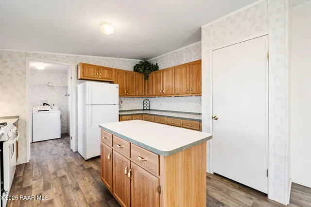 a kitchen with a refrigerator a sink and a stove top oven