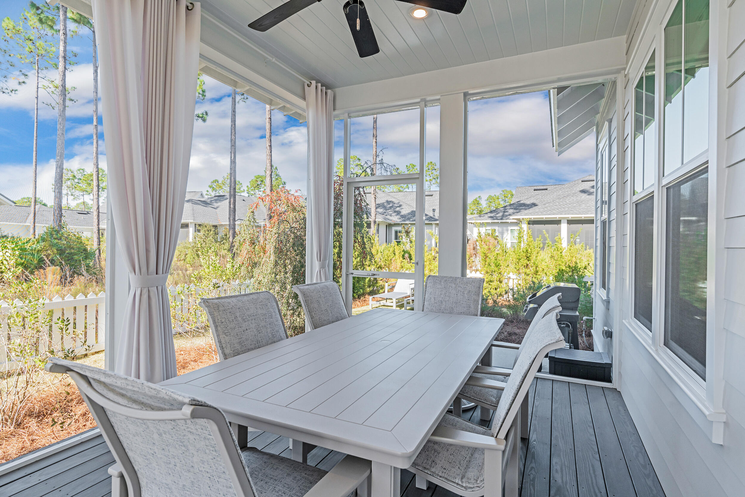 129 Firefly Way, Unit LOT 75 Watersound, FL 32461 - Photo 15 of 56 a view of a dining room with furniture large windows and wooden floor