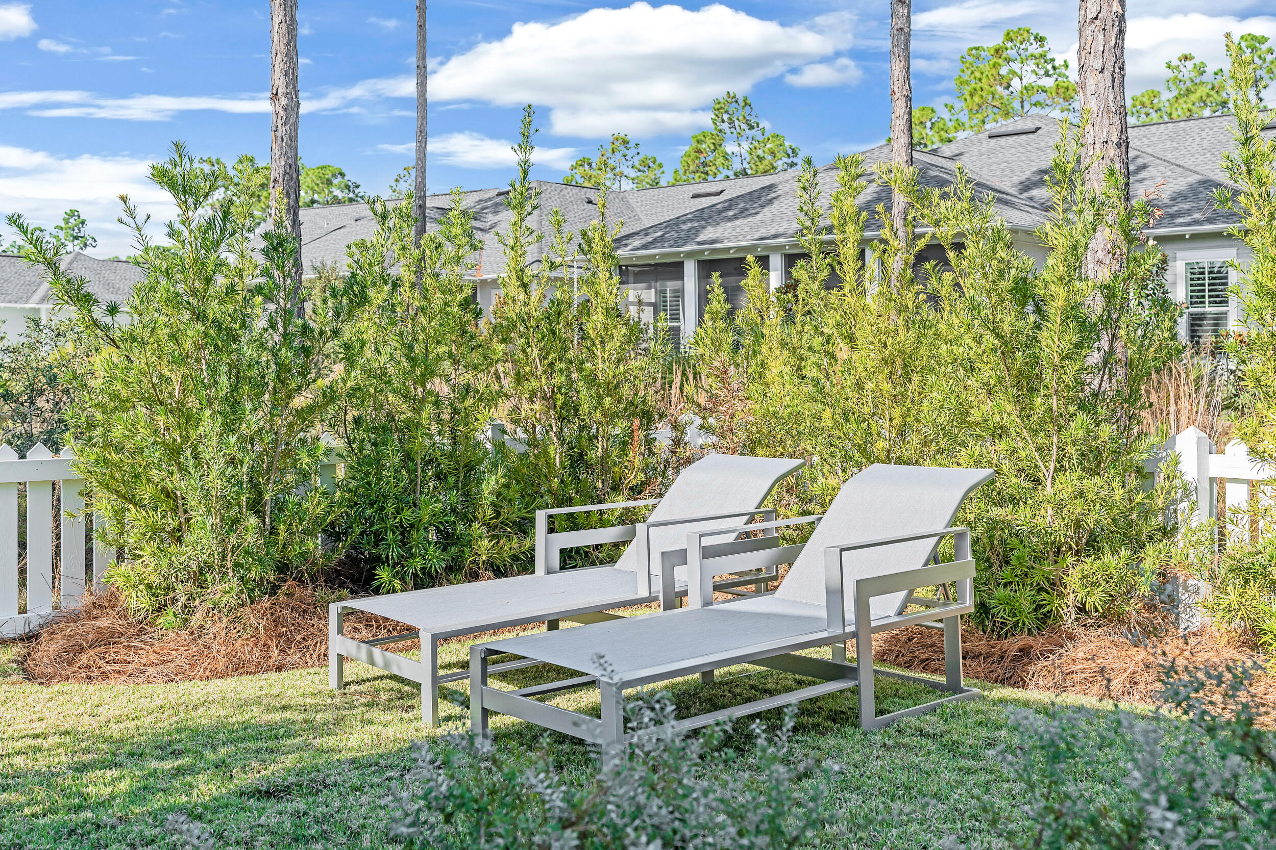 129 Firefly Way, Unit LOT 75 Watersound, FL 32461 - Photo 16 of 56 a view of a patio with table and chairs and potted plants