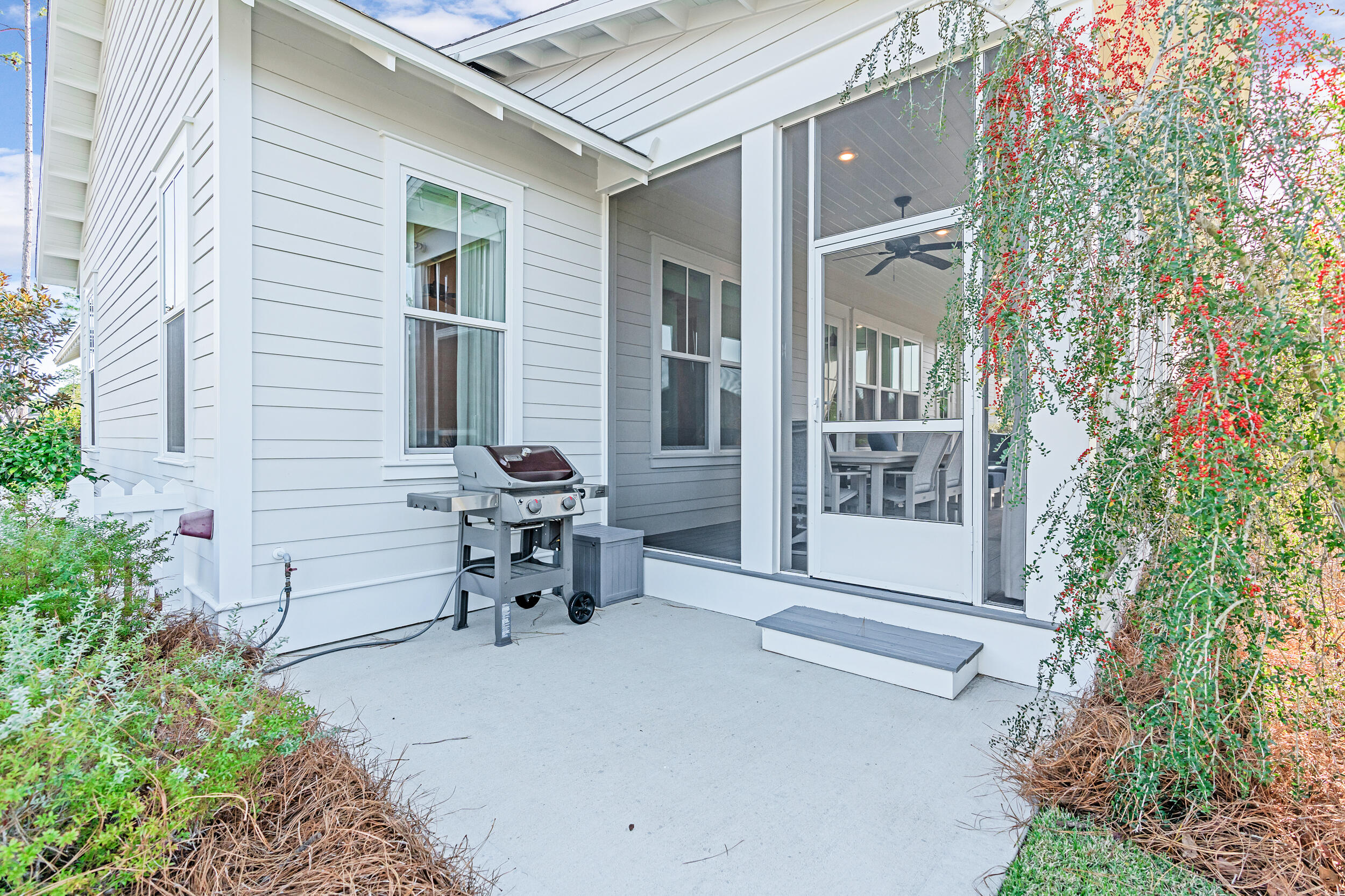 129 Firefly Way, Unit LOT 75 Watersound, FL 32461 - Photo 17 of 56 a view of a patio with table and chairs and potted plants