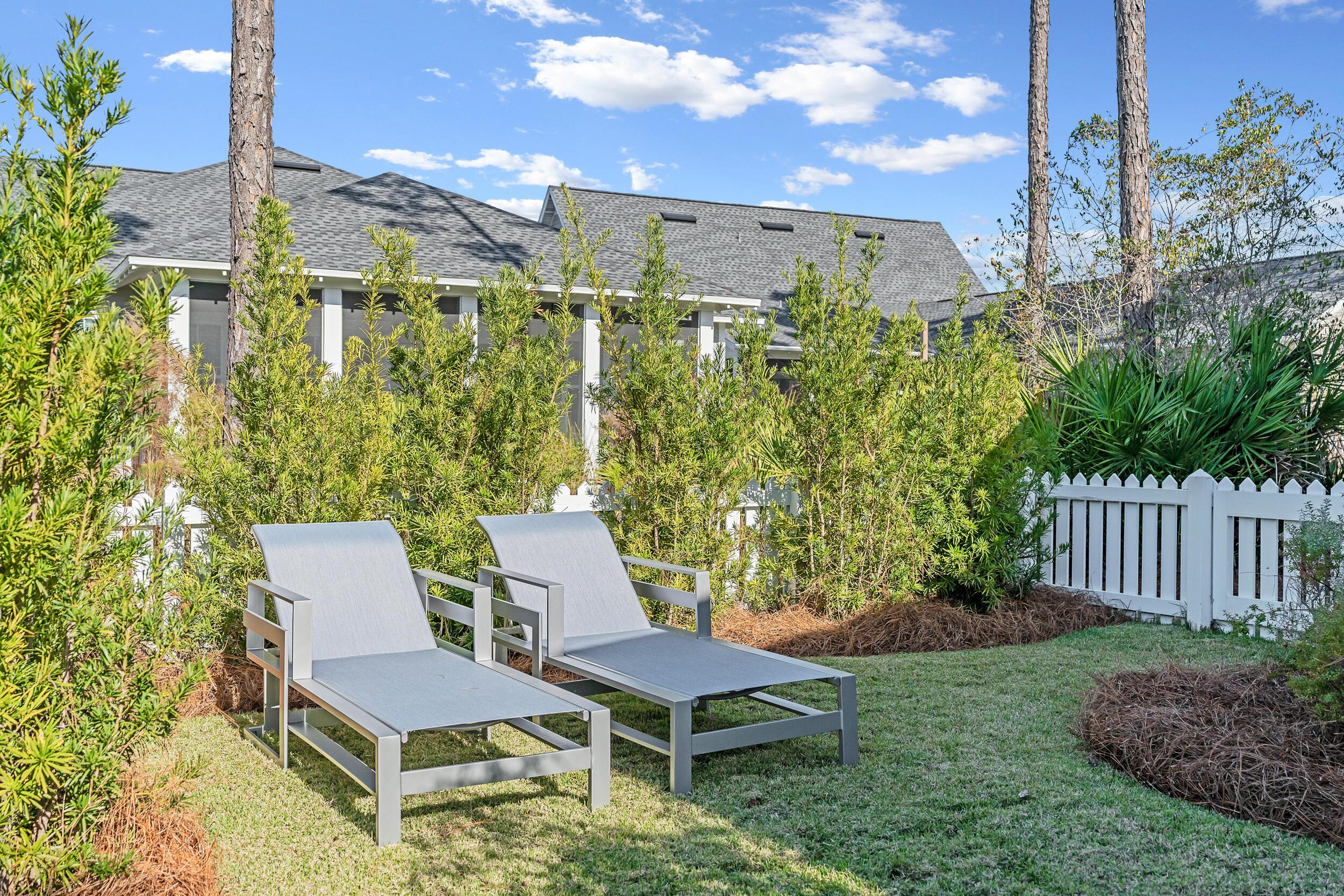 129 Firefly Way, Unit LOT 75 Watersound, FL 32461 - Photo 21 of 56 a backyard of a house with table and chairs