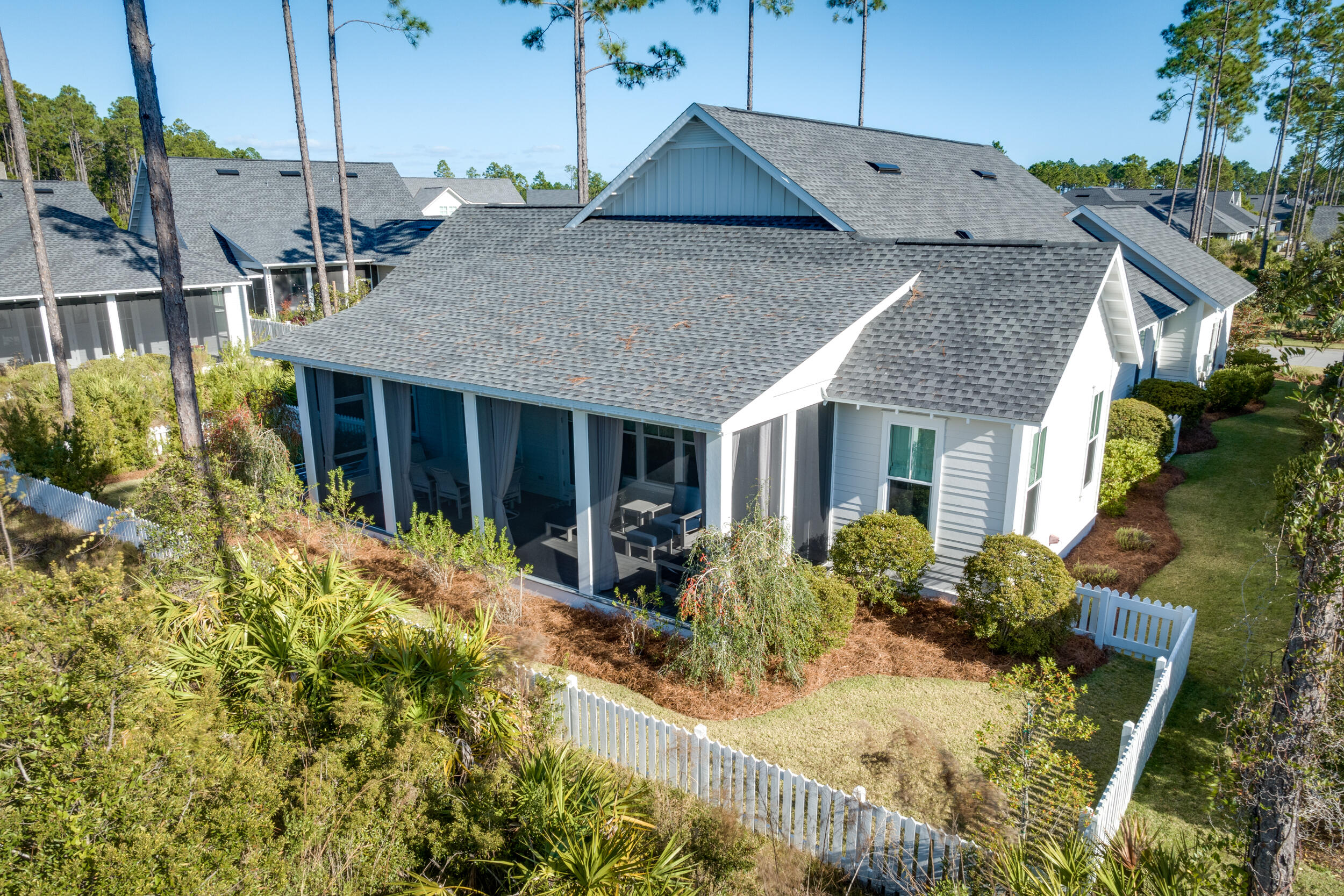 129 Firefly Way, Unit LOT 75 Watersound, FL 32461 - Photo 32 of 56 a front view of house with yard and trees around