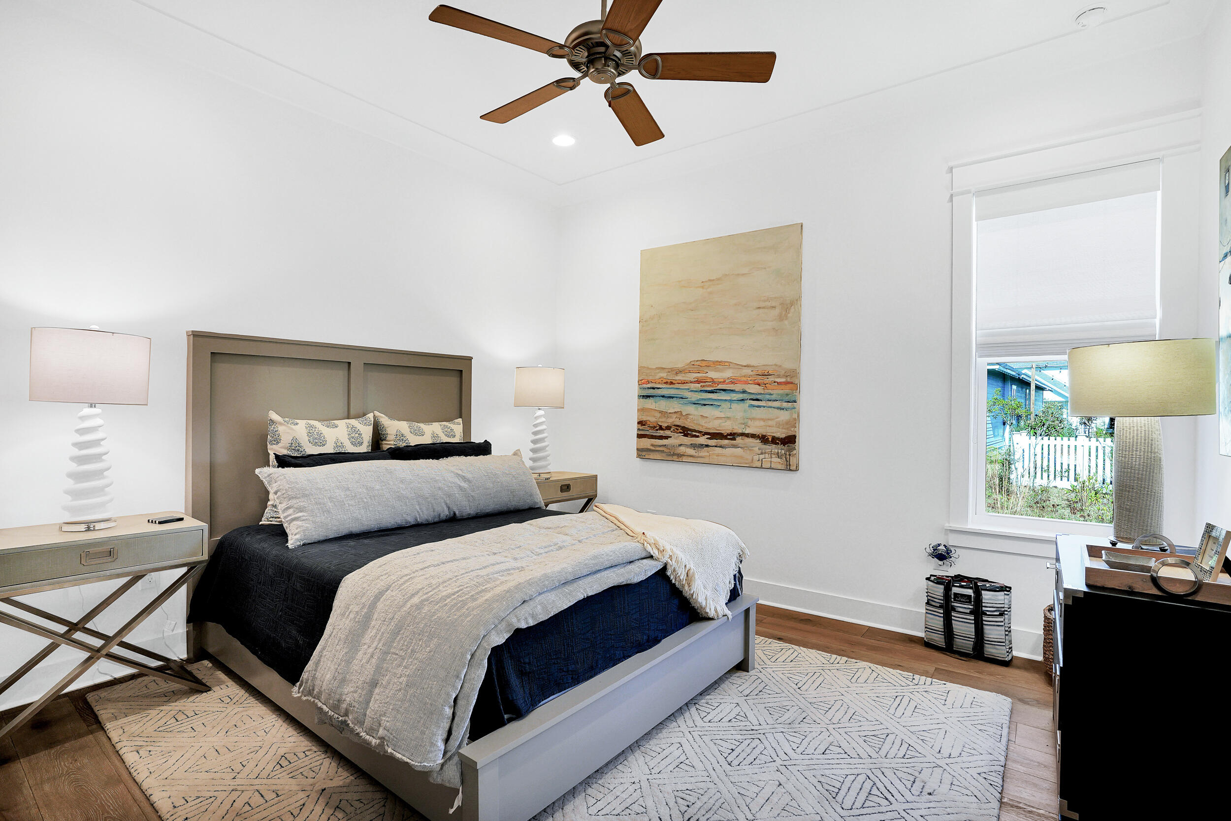 129 Firefly Way, Unit LOT 75 Watersound, FL 32461 - Photo 39 of 56 a bedroom with a bed and wooden floor