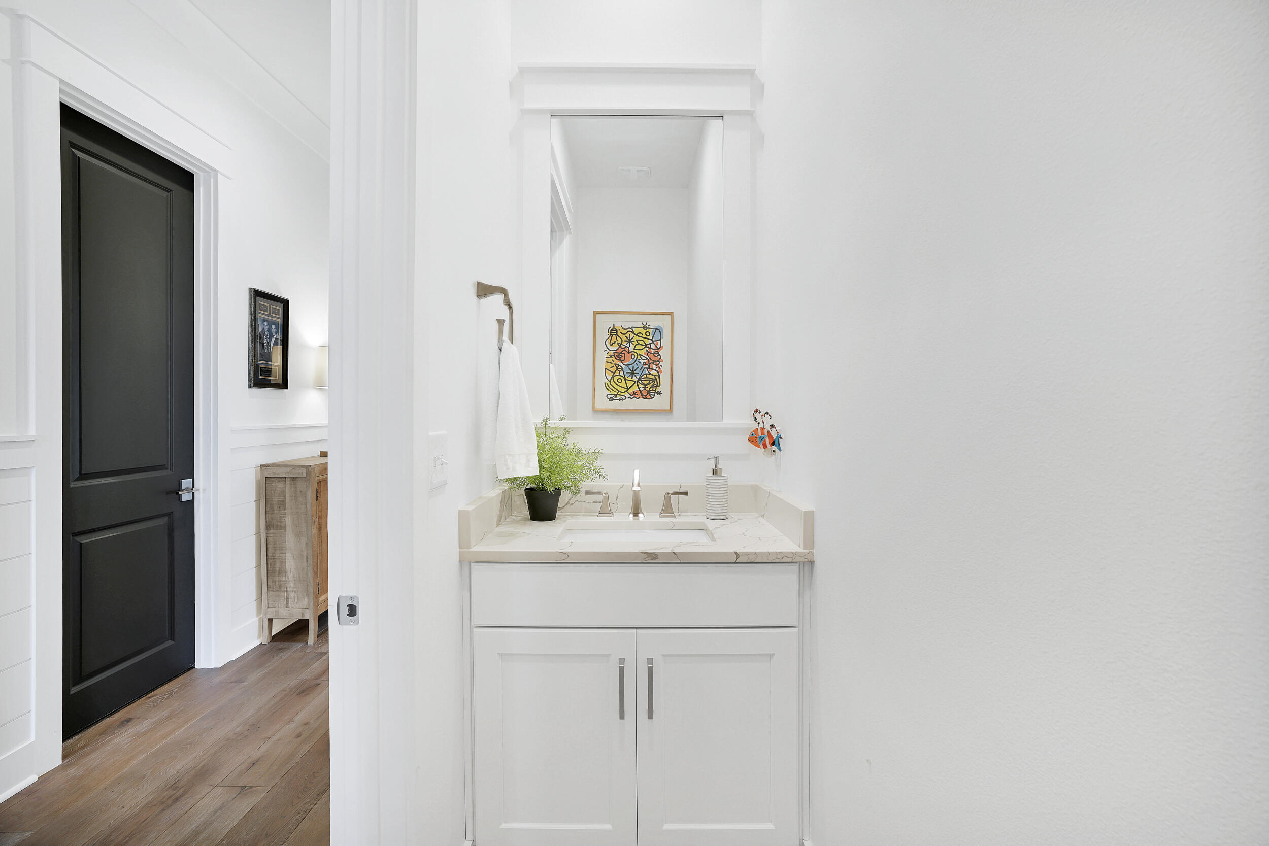129 Firefly Way, Unit LOT 75 Watersound, FL 32461 - Photo 42 of 56 a bathroom with a sink vanity and a mirror