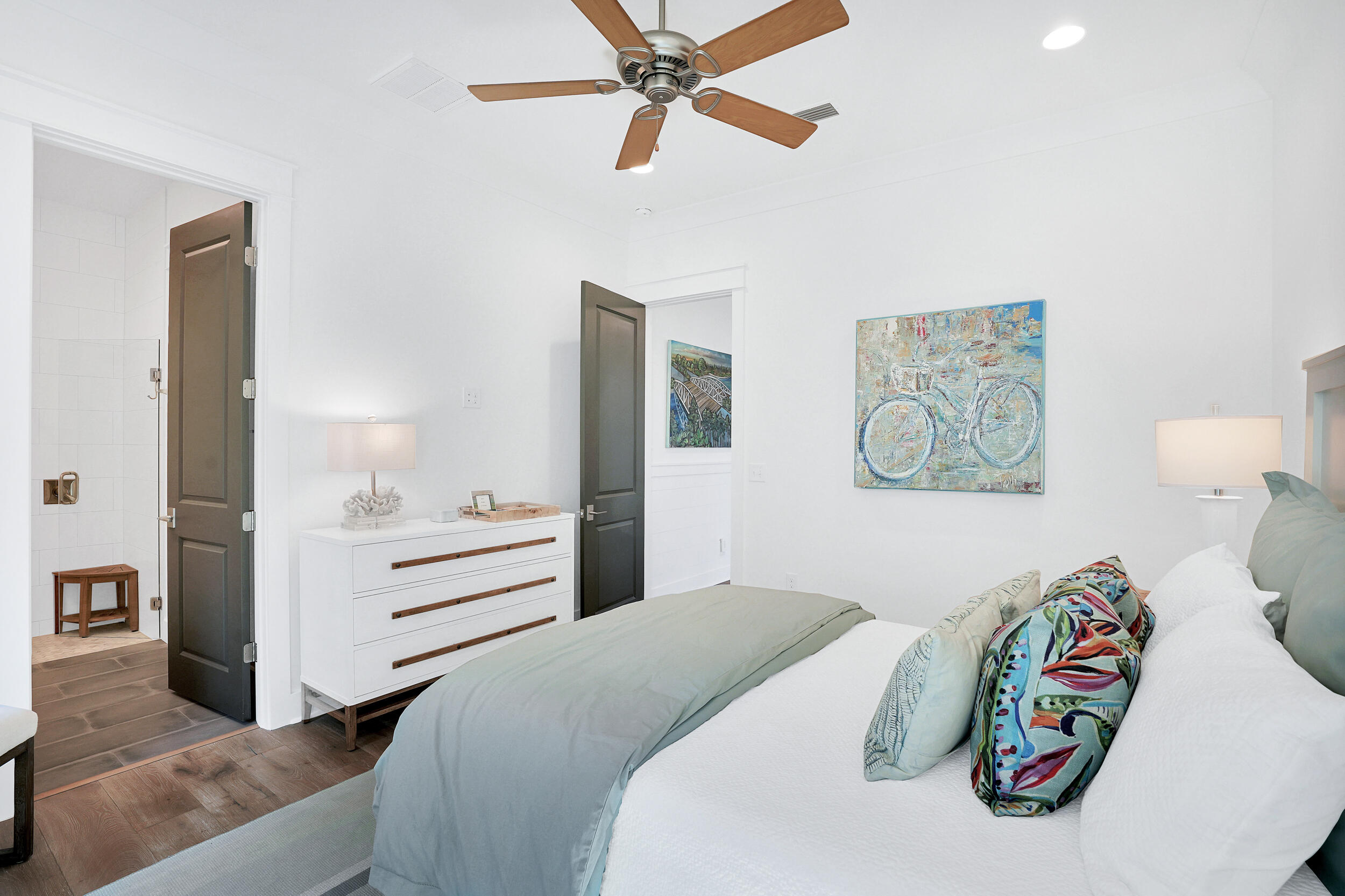 129 Firefly Way, Unit LOT 75 Watersound, FL 32461 - Photo 44 of 56 a bedroom with a bed and a chandelier