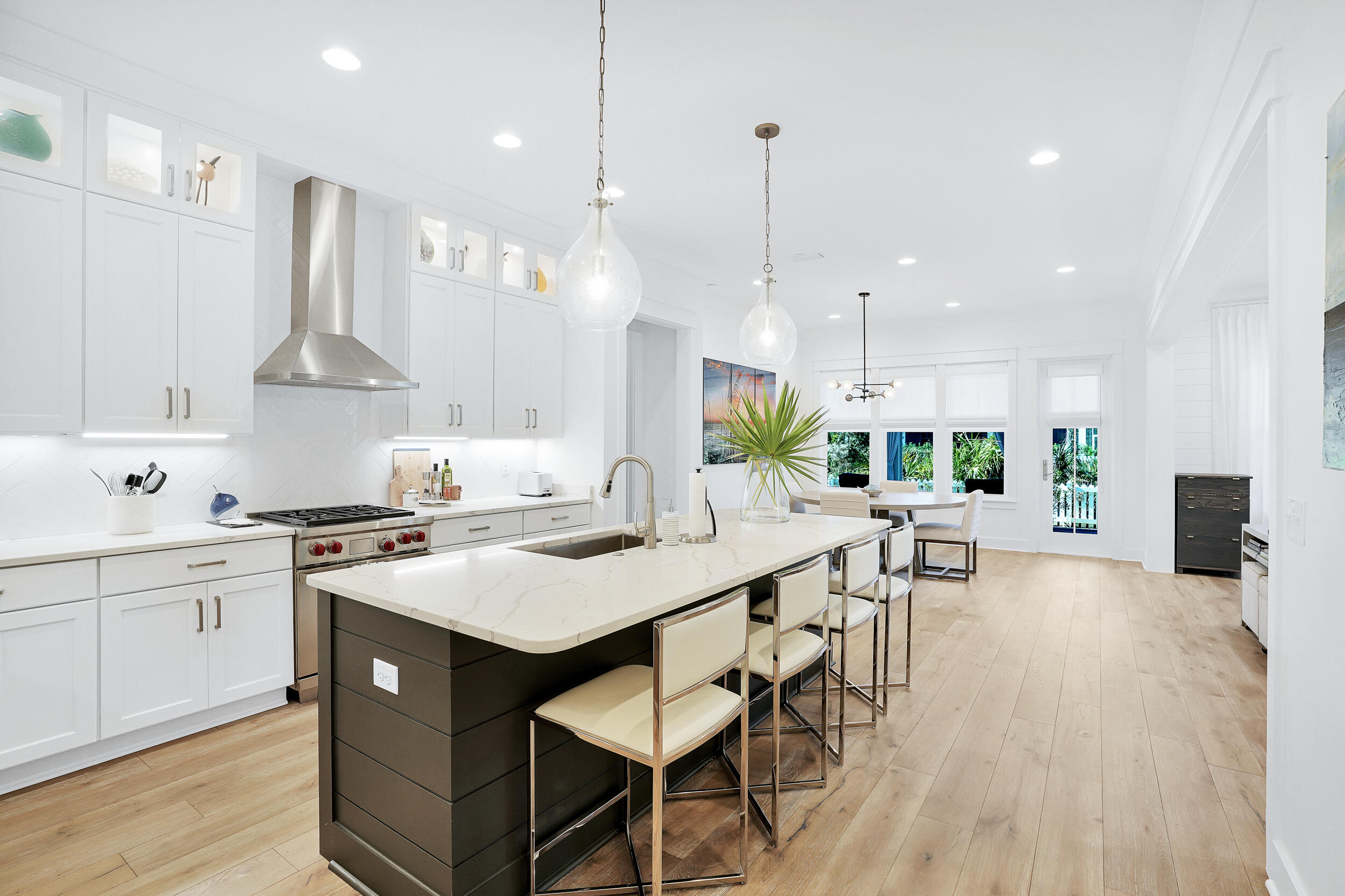 129 Firefly Way, Unit LOT 75 Watersound, FL 32461 - Photo 47 of 56 a kitchen with stainless steel appliances a dining table chairs stove and white cabinets